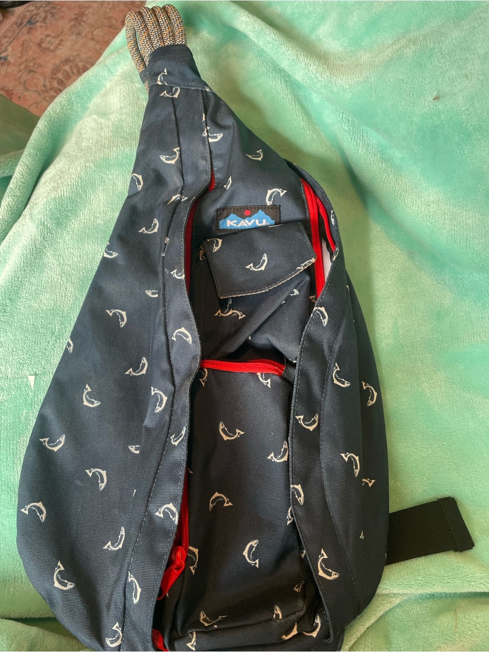 Kavu navy crossbody sling with white bird print and red accents